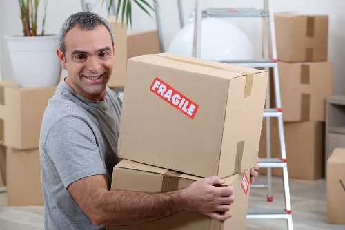 Professional packers carefully packing items for a move